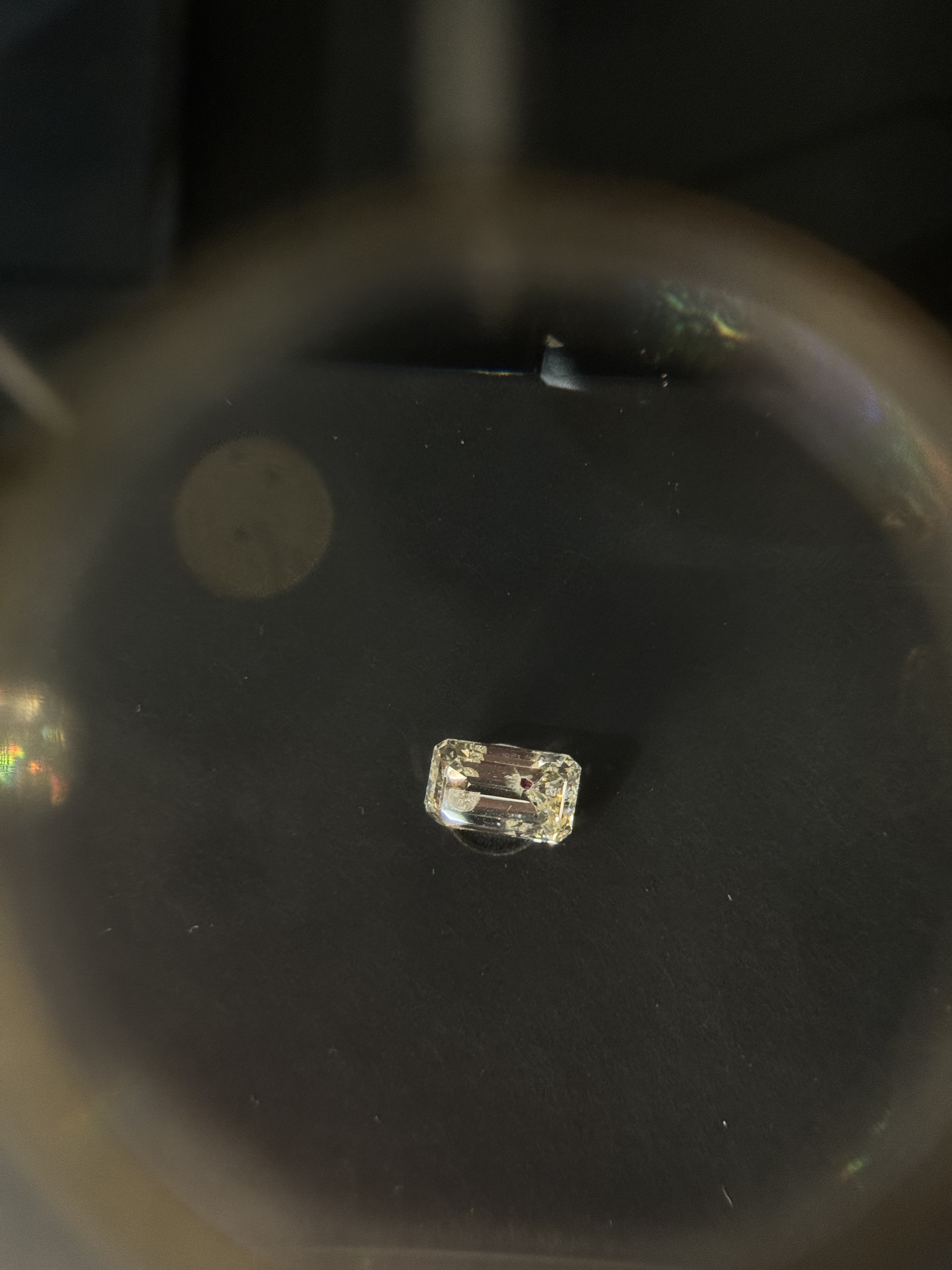 rectangular diamond with small ruby inclusion